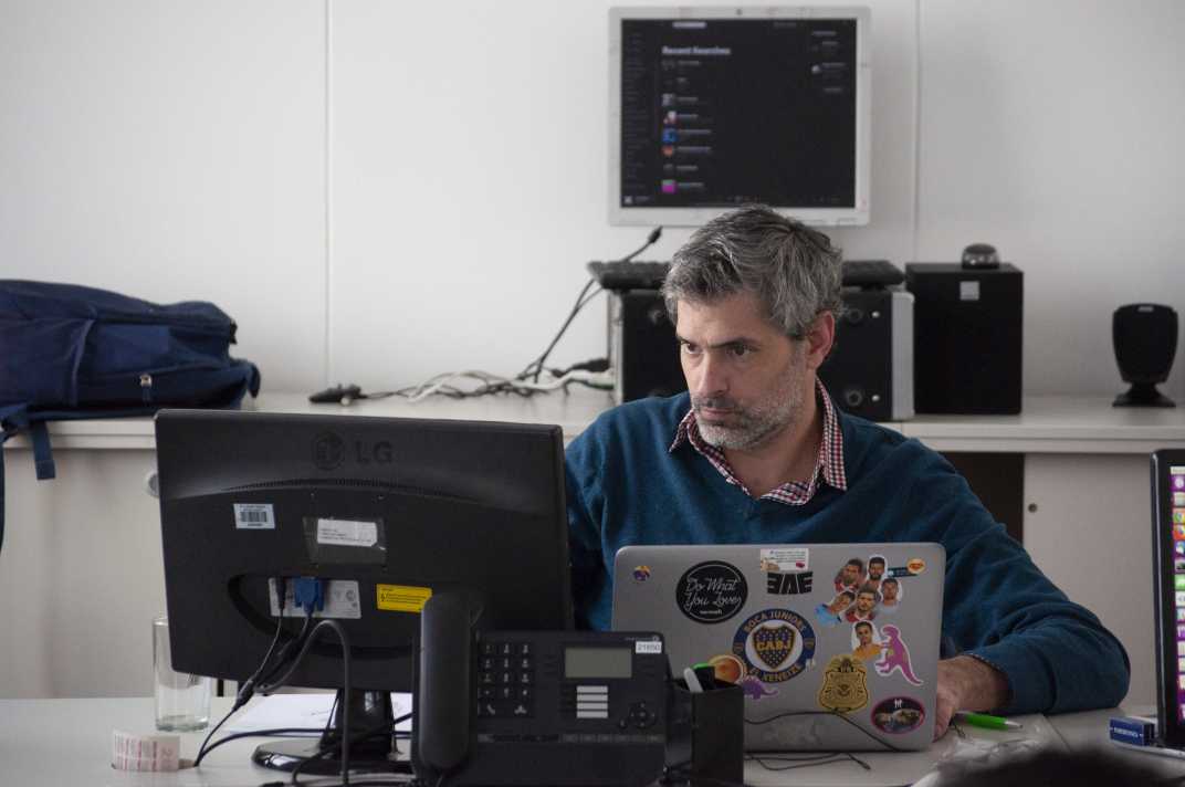 Outsourcing Graphic Design: Your Massive Guide this 2021 12 Man using different graphic design outsourcing tools in a laptop and monitors.
