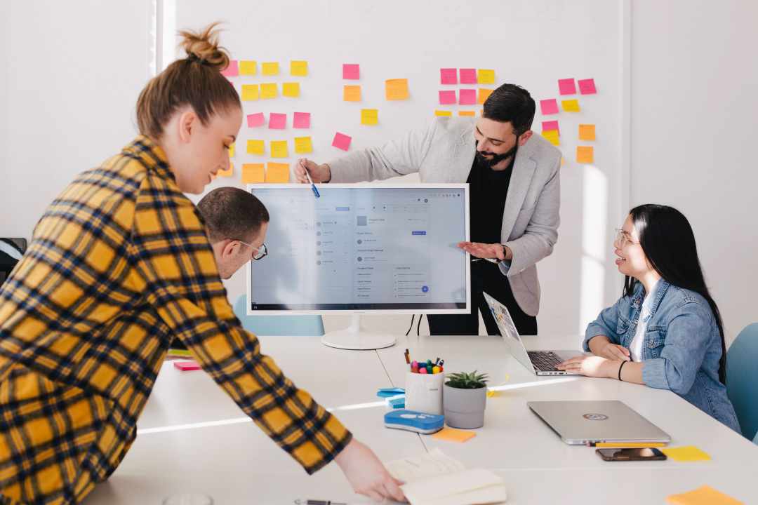 Outsourcing Graphic Design: Your Massive Guide this 2021 11 Man discusses client specifications and key point indicators in graphic design outsourcing.